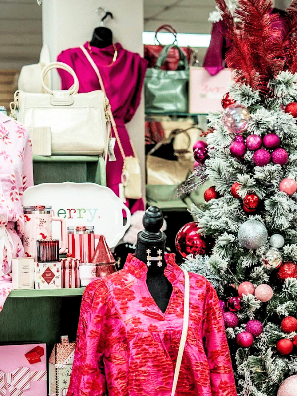 Merle Norman & More Display of Pink Clothes and Christmas Tree